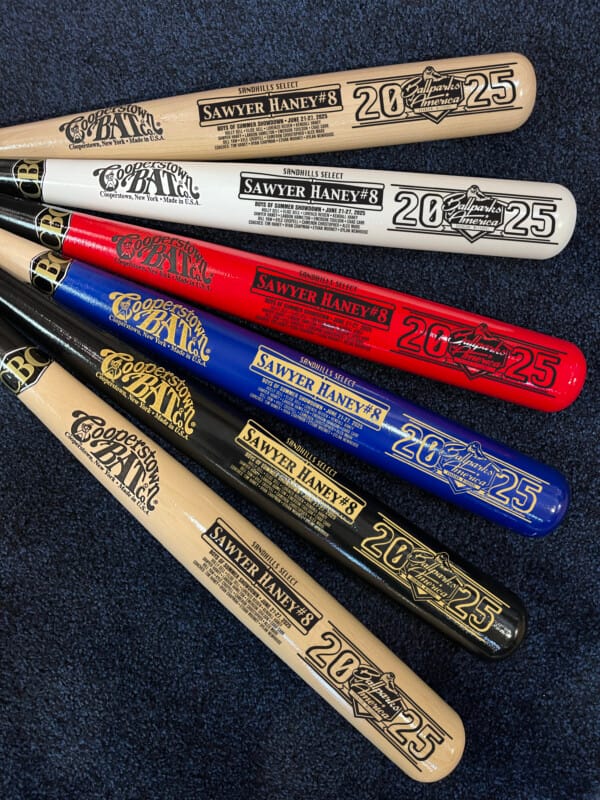 Colorful commemorative baseball bats on display.