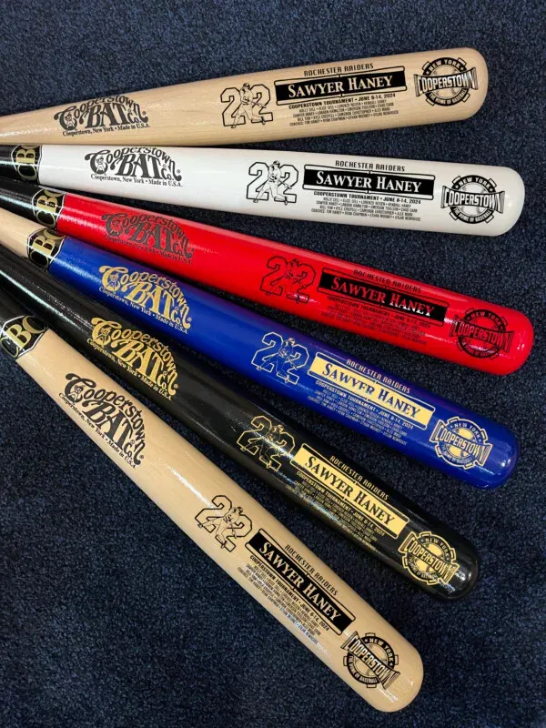 Colorful baseball bats with tournament details.