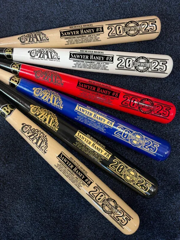 Six colorful baseball bats with custom inscriptions.